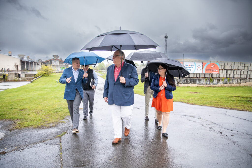 Diane Quennoz, Chief Customer Officer, and Shawn Beqaj, Chief Development Officer, walk with Congressman Marc Molinaro to Archtop Fiber’s storage yard. It’s raining fiber at Archtop, y’all!